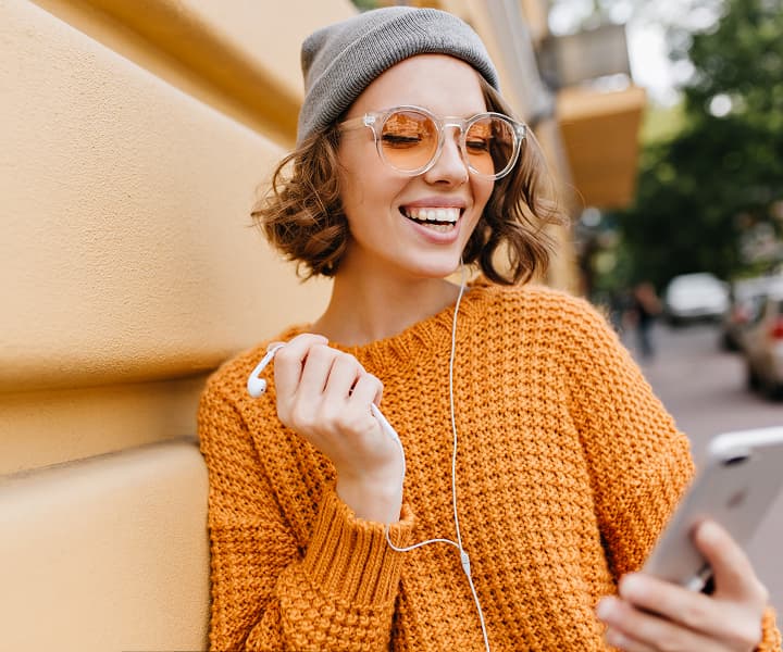 Smiling girl in orange sweater